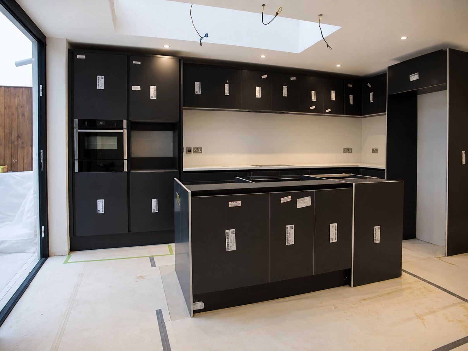 Kitchen cabinetry being carefully installed and aligned