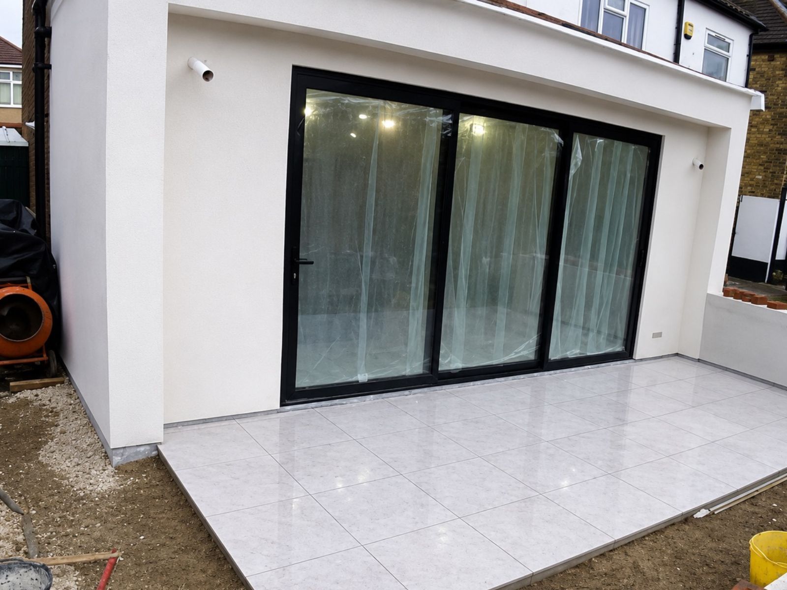 Completed Bromley rear extension with sliding doors and tiled terrace