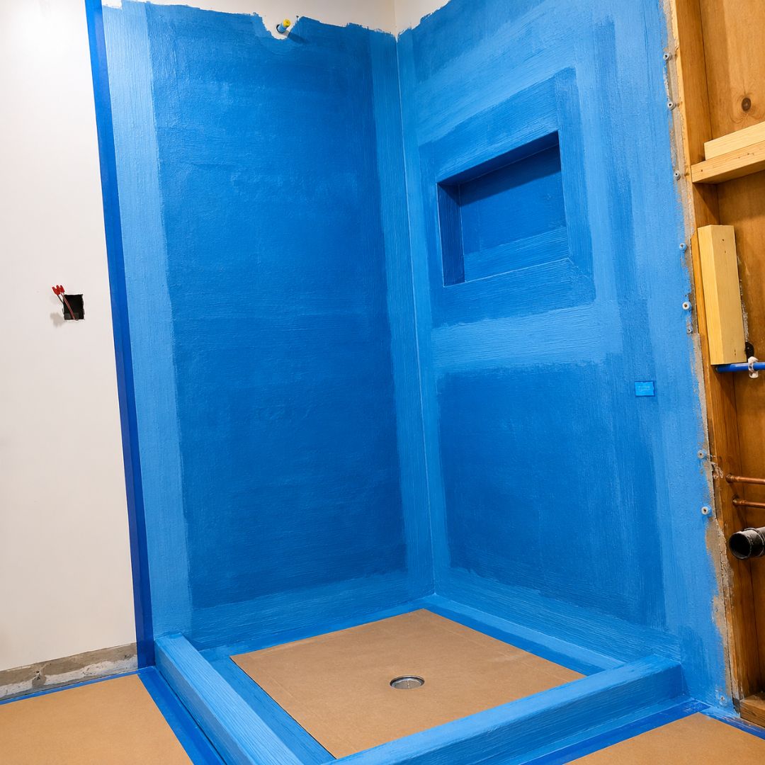 Blue waterproofing applied around the walk-in shower in Chiswick